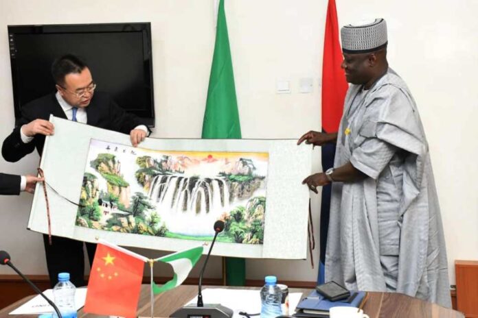 SASTIND delegation from China2 Permanent Secretary, Ministry of Defence, Dr Ibrahim Abubakar Kana, mni, receiving a souvenir from the leader of SASTIND delegation from China, Lin Yunteng, during the visit to Ship House, Abuja.