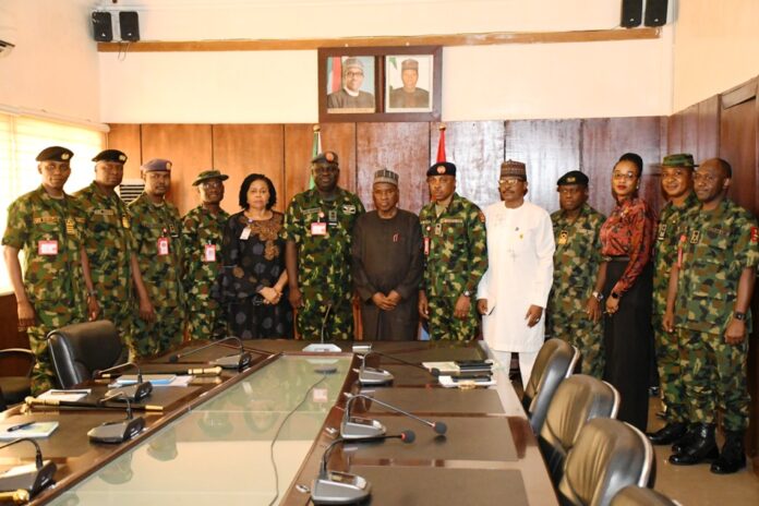courtesy visit to Ship House2 The Minister of Defence, Maj Gen Bashir Salihi Magashi (rtd)(M) and the management team of the Ministry with the Chief of Defence Space Administration, Air Vice Marshal Ayo Jolasinmi (6th L) and his team in a group picture in Ship House, Abuja