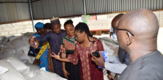 The Director, Animal Husbandry Services, Mrs Winnie Lai Solorin, inspecting Animal Feed at the Workshop.