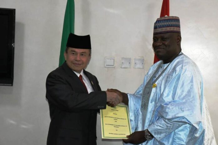 meeting with the Indonesia delegates2 The Minister of Defence, Maj Gen. Bashir Salihi Magashi (rtd) represented by the Permanent Secretary, Ministry of Defence, Dr Ibrahim Abubakar Kana, mni holding the Letter of Intent with the Indonesia Ambassador to Nigeria Dr Hustra Harahap after both parties signed the agreement at Ship House, Abuja