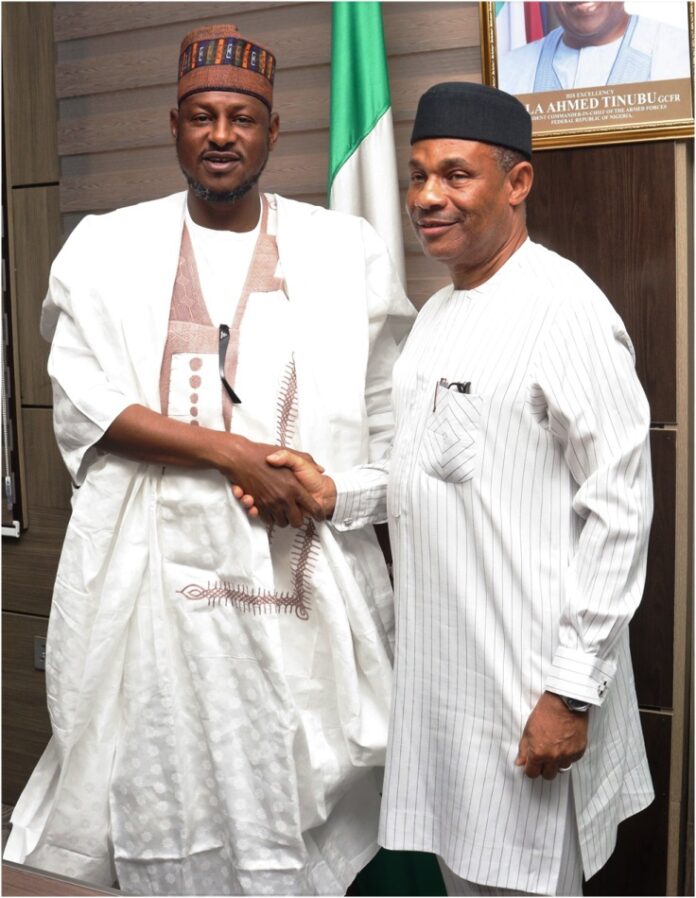 Executive Governor of Katsina state in a handshake with the Permanent Secretary of Ministry of Aviation and Aerospace