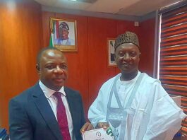 Permanent Secretary, Amb. Gabriel Tanimu Aduda Receiving the Report from Dr. MM Ibrahim