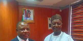 Permanent Secretary, Amb. Gabriel Tanimu Aduda Receiving the Report from Dr. MM Ibrahim