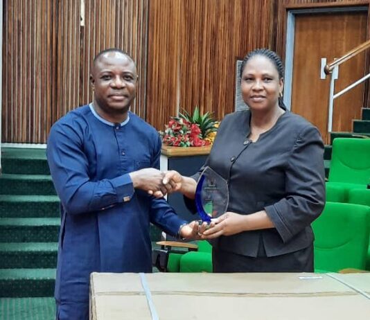 The-PS-Presenting-a-Plaque-and-gift-Items-to-the-representative-of-the-retired-Director-HRM-Mrs.-Funmi-Otu-Bassey.