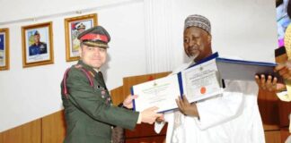Minister of Defence, Mohammed Badaru Abubakar CON,mni presenting certificates to one of the Graduands at the Graduation ceremony of Nationa Defence College (NDC) COURSE 31 at Abacha Hall, NDC , Abuja.