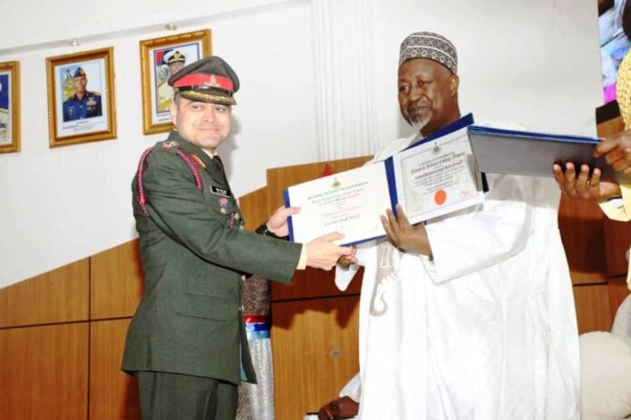 Minister of Defence, Mohammed Badaru Abubakar CON,mni presenting certificates to one of the Graduands at the Graduation ceremony of Nationa Defence College (NDC) COURSE 31 at Abacha Hall, NDC , Abuja.