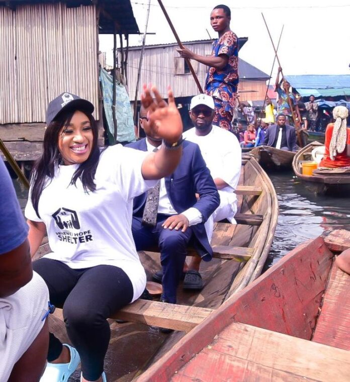 Honourable Minister of Humanitarian Affairs and Poverty Alleviation, Dr. Betta Edu (in front waiving) taking a canoe trip to one of the Communities in Makoko, a lagos suburb to flag off the National Social Register verification, over the weekend.
