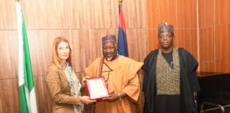 Minister of Defence Mohammed Badaru Abubakar CON, mni (m) alongside Minister of State Defence Dr. Bello Muhammed Matawalle (r) presenting a plague to the Deputy Secretary General of EEAS, European Union Helena Konig , during a courtesy visit in Ship House, Abuja.