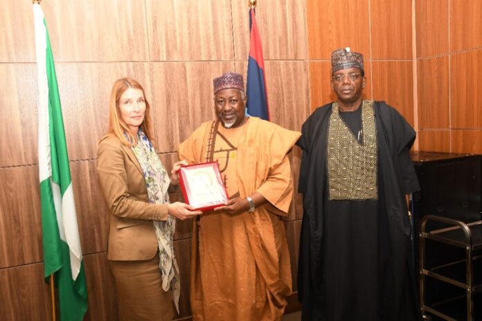 Minister of Defence Mohammed Badaru Abubakar CON, mni (m) alongside Minister of State Defence Dr. Bello Muhammed Matawalle (r) presenting a plague to the Deputy Secretary General of EEAS, European Union Helena Konig , during a courtesy visit in Ship House, Abuja.