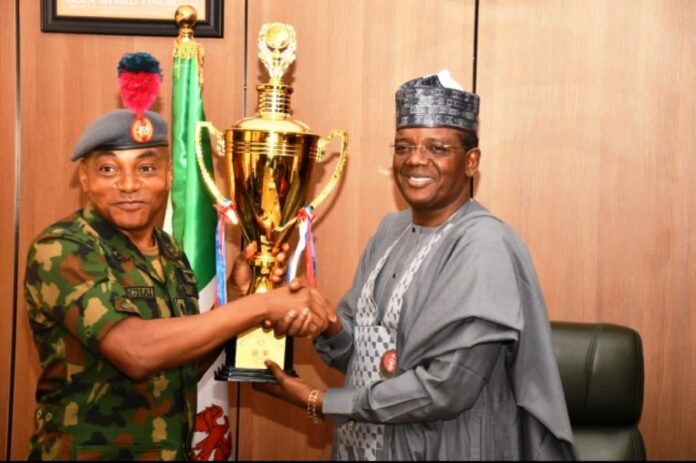 trophies won by the Navy cadets in China Minister of Defence for State Dr Muhammad Bello Matawalle receiving the trophies won by the Navy cadets in China during the sailing competition from Maj Gen JO Ochai, the Commandant of Nigeria Defence Academy (NDA) in Ship House, Abuja