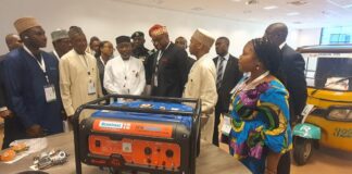 The Minister (3rd left) flanked by other dignitaries listening to presentation on how Liquefied Petroleum Gas (LPG) can power Four Stroke Engine Tricycle and Petro Generator while inspecting various Exhibition Stands at the ongoing 13th LPGAS Conference and Exhibition in Abuja.