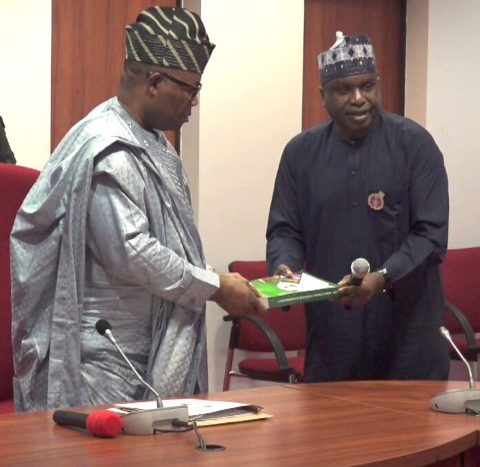 Malam Shehu Ibrahim presenting a copy of the Compendium to the Senate President Senator Godswill Obot Akpabio (R-L) Perm Sec Ecological Project Office, Malam Shehu Ibrahim, presenting a copy of the Compendium to the Senate President, Senator Godswill Obot Akpabio