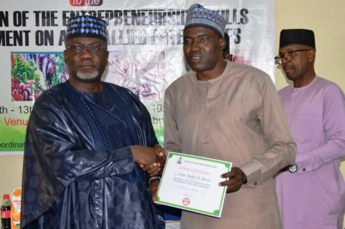Certificate of Attendance Permanent Secretary, FMAFS, Dr Ernest Umakhihe, presenting Certificate of Attendance to Deputy Director, Engr. Julius Ayodele during the workshop in Abuja