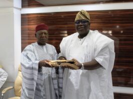 R-L: Incoming Chairman, Prof. Tunji Olaopa received hand-over documents from Dr. Jonah Madugu- former acting Chairman.