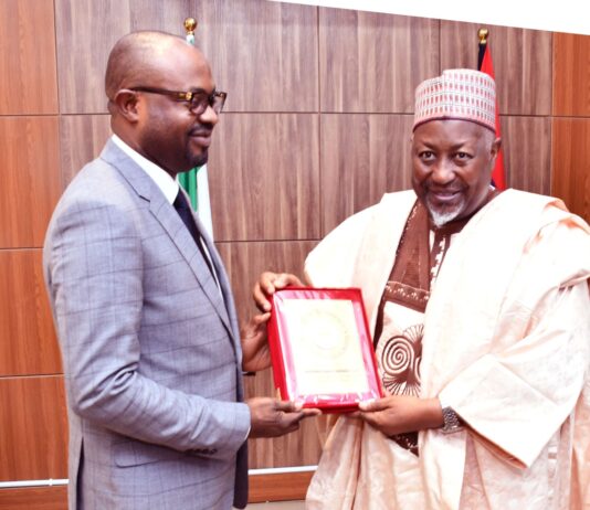 The Minister of Defence, Muhammad Badaru Abubakar, CON presenting a plague to Minister of Interior, Hon. Olubumi Tunji Ojo when the later paid a courtesy visit to Ship House, Abuja on Tuesday, 14th November, 2023.