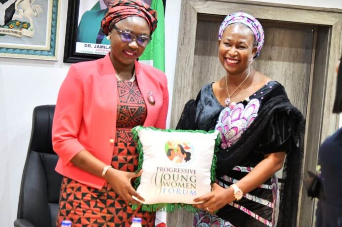 Hon. Min. of Youth Development, Dr. Jamila Bio-Ibrahim Hon. Minister of Youth Develooment, Dr. Jamila Bio-Ibrahim receiving a present from the National President of the Progressive Young Women forum , Hon. Patience Kwache during their courtesy call on the Minister.