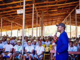 Mr Ayodele Olawande the Hon. Minister of State for Youth Development addressing the Corps members during his visit to their camp at Asaya in Kabba, Kogi state.