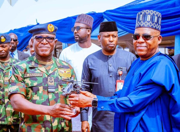 End Insecurity1 Vice President Kashim Shettima receives a prototype of the T129 ATAK helicopter from Chief of Air Staff, Air Marshal Hassan Abubakar during the induction ceremony of T129 ATAK Helicopter and Beechcraft King Air 360ER by the Nigeria Airforce at the Nigeria Airforce Base, Makurdi, Benue State on Tuesday, 6th February, 2023.