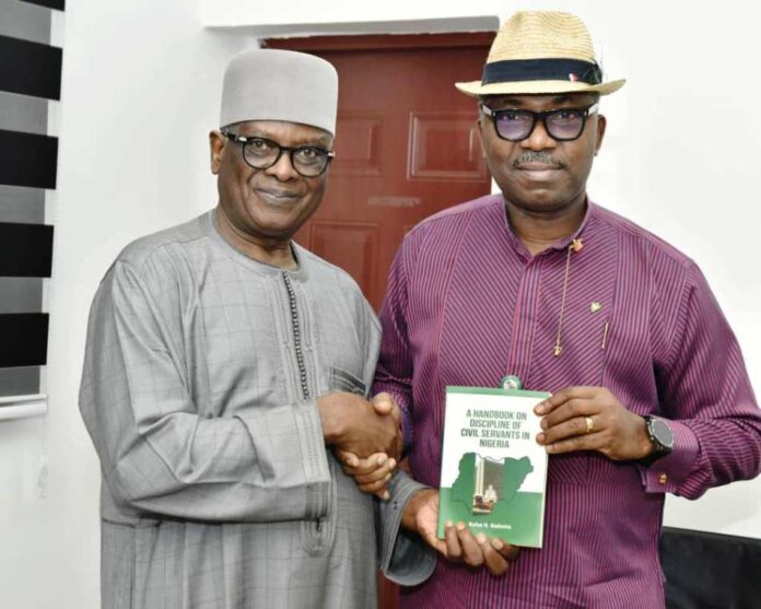 l-r: Director-General, BPP, Mamman Ahmadu, FNIQS, being presented with a book titled "Discipline of Civil Servants in Nigeria" by the Author, Hon. Commissioner, Rivers, Bayelsa & Delta States Hon. Rufus N. Godwins during his visit to the Bureau