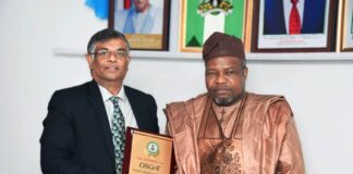 FROM RIGHT: SGOF, Surv. Abuduganiyu Adebomehin mnis, fce, presenting sourvenir to the Indian High Commissioner to Nigeria Ambassador Shri G. Balasubramanian during an interactive session with the Indian delegation who visited the SGOF in his Office in Abuja