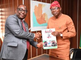 Hon. Minister of State for Environment, Dr Iziaq Adekunle Adeboye Salako right, receiving some journals from the President of Nigerian Mining and Geosciences Society, Prof. Akinade Olatunji during the courtesy visit to the Minister in Abuja.