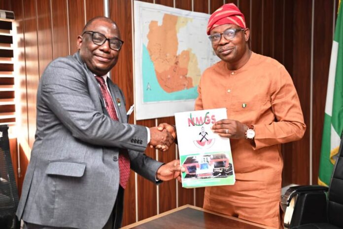 Min. of Environment Hon. Minister of State for Environment, Dr Iziaq Adekunle Adeboye Salako right, receiving some journals from the President of Nigerian Mining and Geosciences Society, Prof. Akinade Olatunji during the courtesy visit to the Minister in Abuja.