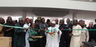 Minister of Special Duties and Inter-governmental Affairs, Zaphaniah Jisalo, (m) commissions the equipment assisted by dignitaries at the event