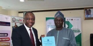 From L - R; Permanent Secretary, Federal Ministry of Women Affairs, Amb. Gabriel Aduda, receiving the Handing Over Notes from the Director Overseeing the Office of the Permanent Secretary, Mr. Francis Adebisi at the Ministry's Conference Room in Abuja