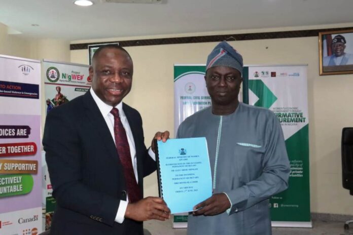 From L - R; Permanent Secretary, Federal Ministry of Women Affairs, Amb. Gabriel Aduda, receiving the Handing Over Notes from the Director Overseeing the Office of the Permanent Secretary, Mr. Francis Adebisi at the Ministry's Conference Room in Abuja