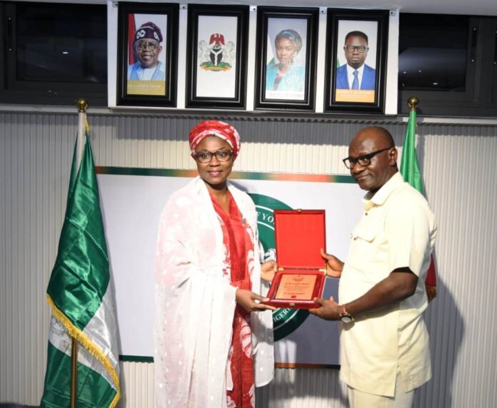 courtesy visit of the delegates from IPCR4 The Honourable Minister of Youth Development, Dr. Jamila Bio-Ibrahim receiving a plague from the DG, IPCR, Dr. Joseph Ologwu during a courtesy visit of the delegates from IPCR to the Ministry of Youth Development in Abuja.
