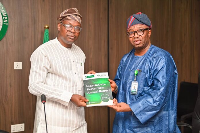 official working visit 2 The Hon. Minister of State for Environment, Dr. Iziaq Adekunle Adeboye Salako (left), receiving the Nigeria Data Protection Annual Report from CEO, NDPC, Dr. Vincent Adetola during the Commission's courtesy visit to the Ministry in Abuja