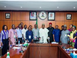 The honourable Minister of Budget and Economic Planning, Sen. Abubakar Atiku Bagudu flanked to the right by the Permanent Secretary of the Ministry, Engr. Nebeolisa Anako and members of the press