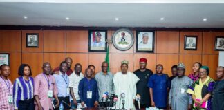 The honourable Minister of Budget and Economic Planning, Sen. Abubakar Atiku Bagudu flanked to the right by the Permanent Secretary of the Ministry, Engr. Nebeolisa Anako and members of the press