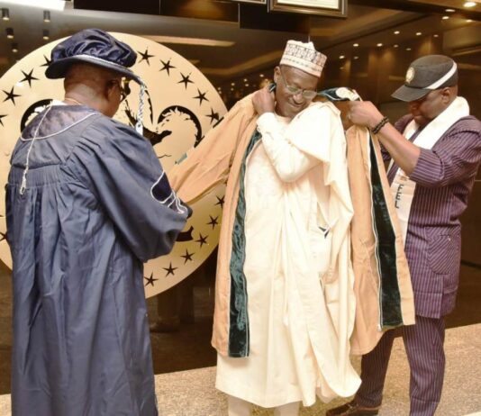 Housing Minister, Arc Ahmed Dangiwa being decorated Honorary Fellow of the NIOB during a courtesy visit of the President of NIOB to his office.