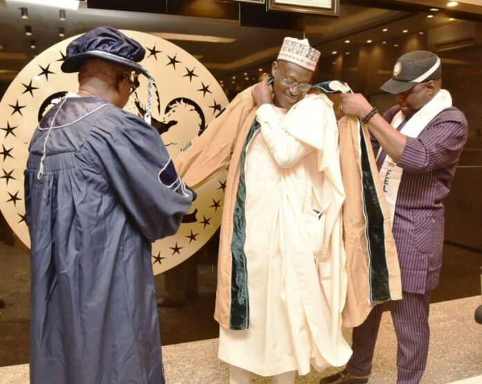 Honorary Fellow of the NIOB4 Housing Minister, Arc Ahmed Dangiwa being decorated Honorary Fellow of the NIOB during a courtesy visit of the President of NIOB to his office.