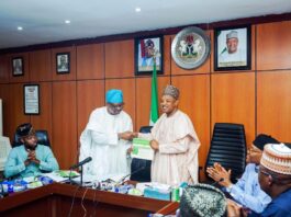 Rt. Hon. Isiaka Ibrahim Ayokunle presenting the workplan/ proposal on an effective budget process to the Hon. Minister of Budget and Economic Planning, in his office yesterday.