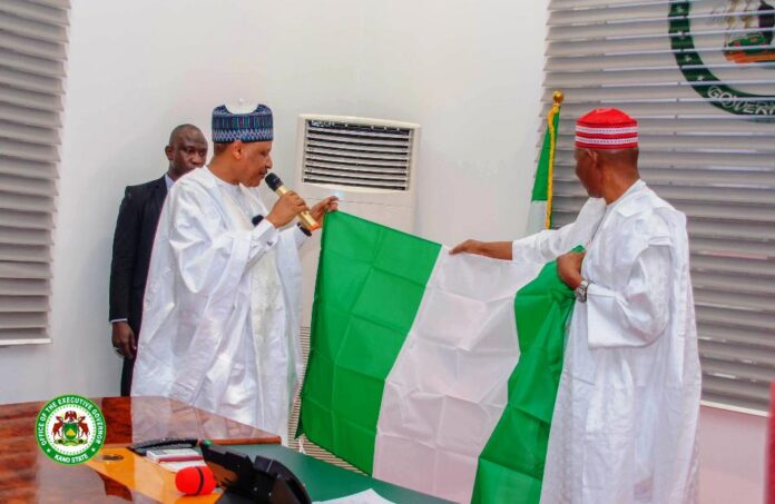 Kano State Insecurity2 HE Governor Abba Kabir Yusuf's of Kano State presenting the National Flag to the Hon. Minister of Information and National Orientation, Alhaji Mohammed Idris Malagi