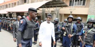 The Honourable Minister Dr Dele Alake being assisted by the Commander of the contingent to inspect the Guard of Honour mounted by the contingent of Mining Marshals at the premises of the Ministry.