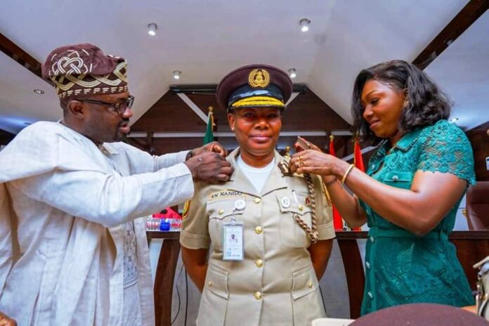 New Immigration CG Minister of Interior, Hon. Dr. Olubunmi Tunji-Ojo, decorating the newly appointed Comptroller General of Immigration Service (CGIS), Kemi Nanna Nandap