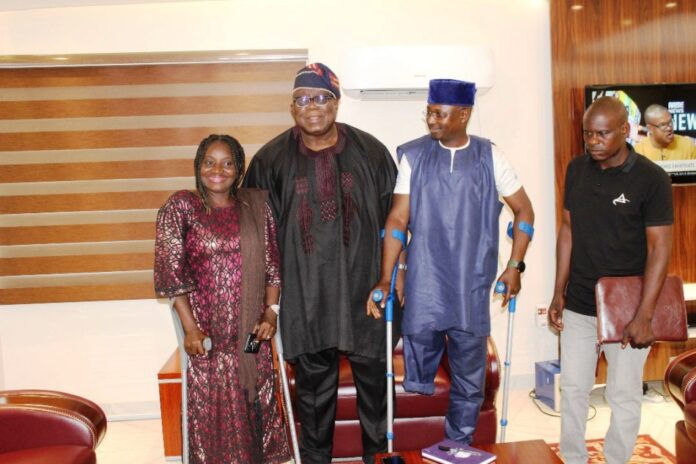 Hon. Chairman, Federal Civil Service Commission (FCSC), Prof. Tunji Olaopa (Middle in Black) with the President, PLWD group, Mr. Joshua Dauda Bungon (Immediate Right) and other members of the association during their courtesy visit to the Chairman.