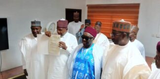 Permanent Secretary, Dr. Nasir Sani Gwarzo, Honourable Minister of Police Affairs, Senator Ibrahim Gaidam , Emir of Fika and Chairman of Yobe State Council of Traditional Rulers, Alhaji Dr. Muhammadu Abali Ibn Muhammadu during the presentation of a certificate of Wakama of Fika Emirate at the Headquarters of the Ministry of Police Affairs, Abuja.