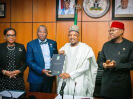 The President and Chairman of the Nigerian Council of Registered Insurance Brokers (NCRIB) Prince Babatunde Oguntade FIIN, FCIB presenting a compendium on NCRIB@ 60 to the Hon. Minister Sen. Abubakar Atiku Bagudu in his office, while the Permanent Secretary FMBEP Mr. Nebolisa Anako looks on.
