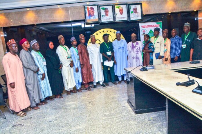 Hon Minister and Minister of State,,Housing and Urban Development, Arc Ahmed Musa Dangiwa and Abdullahi Tijjani Gwarzo in a group photograph with members of the National Association of Directors and Heads of Local Govt Departments of Works, Housing, Transport and Environment during their visit