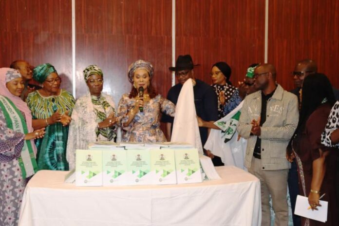 Honourable Minister of Women Affairs, Barrister (Mrs) Uju Kennedy-Ohanenye Unveiling the National Guidelines on Women and Girls' Empowerment for Optimal Nutrition in Abuja today. To her left is the Representative of the Permanent Secretary, Mr. Tony Iwere
