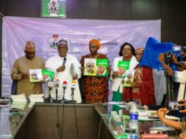 L-R, Dr Tunji Alausa,HMSH, Prof Muhammad Ali Pate,CMH&SW,Daju Kachollom mni, PSH,Dr.Binyerem Ukaire,DIRECTOR Family Health and Mrs.Ladidi Bako-Aiyegbusi Director Nutrition display the 2 documents on Labour Guide and Guidelines for Community Use of Misoprostol.
