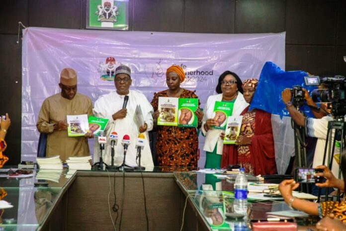 L-R, Dr Tunji Alausa,HMSH, Prof Muhammad Ali Pate,CMH&SW,Daju Kachollom mni, PSH,Dr.Binyerem Ukaire,DIRECTOR Family Health and Mrs.Ladidi Bako-Aiyegbusi Director Nutrition display the 2 documents on Labour Guide and Guidelines for Community Use of Misoprostol.