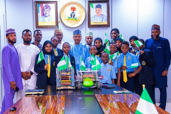 Nigerian delegates to global robotics meeting Minister of Information and National Orientation, Mohammed Idris (center), in a group photograph with the students, coaches, and the school's Executive Director, Abba Said (Extreme right)