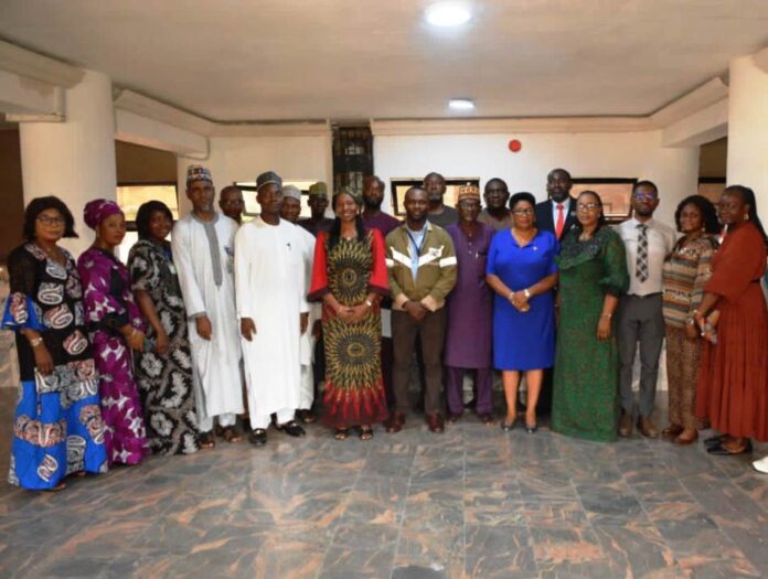 Representative of the Head of Service, Dr Comfort Adeosun (6th L) in a group photograph with members of the Safety, Health and Hazard Control Committee, after the inauguration in Abuja.