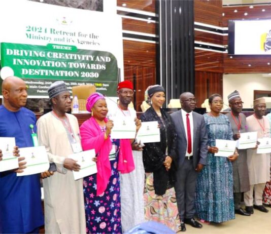 HON.MINISTER FMACCE HANNATU MUSA MUSAWA, PERM. SEC. JAMES SULE AND THE DIRECTORS OF THE MINISTRY AFTER SIGNING THE PERFORMANCE BOND.
