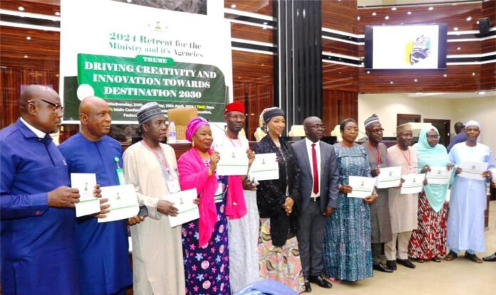 SIGNING THE PERFORMANCE BOND HON.MINISTER FMACCE HANNATU MUSA MUSAWA, PERM. SEC. JAMES SULE AND THE DIRECTORS OF THE MINISTRY AFTER SIGNING THE PERFORMANCE BOND.